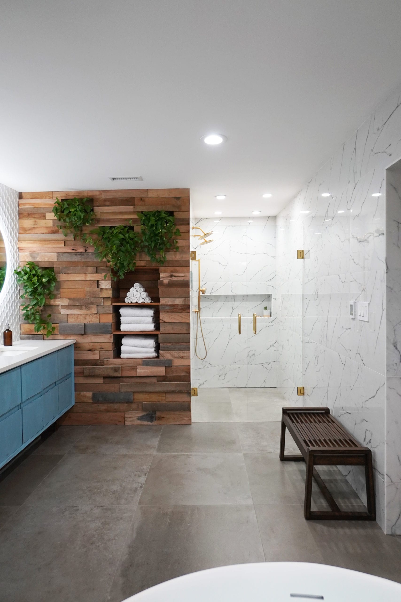 luxury bathroom remodel ideas plant wall wood wall marble shower blue vanity concrete bathroom