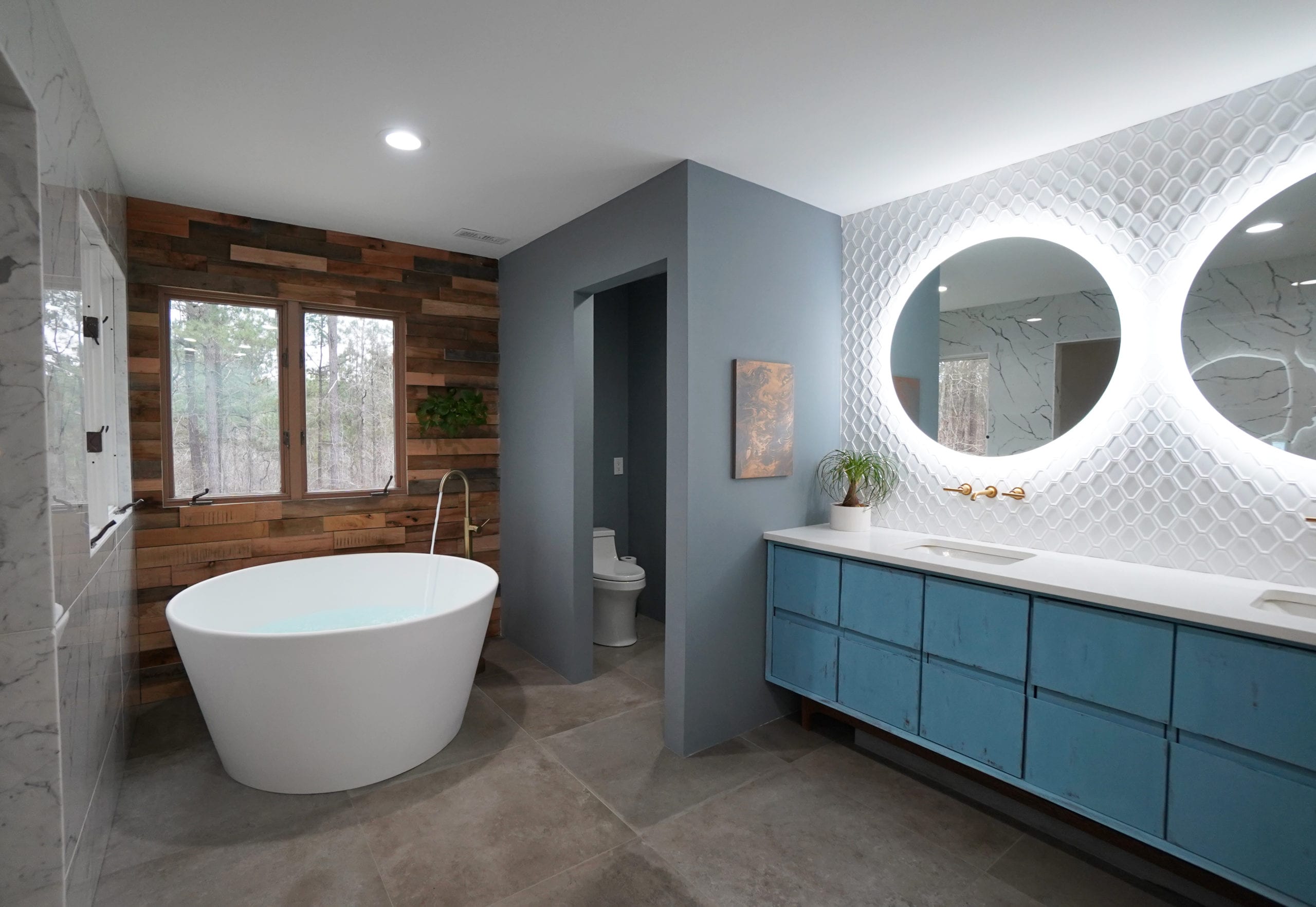 Round tub, bathtub ideas wood wall bathroom plant wall open water closet blue vanity round bathroom mirrors round mirrors medicine cabinet ideas