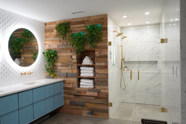 Bathroom Remodel Company in Atlanta with contemporary vanity, marble tile, walk in shower, gold shower, gold faucets, wood wall, white tile, round mirrors.
